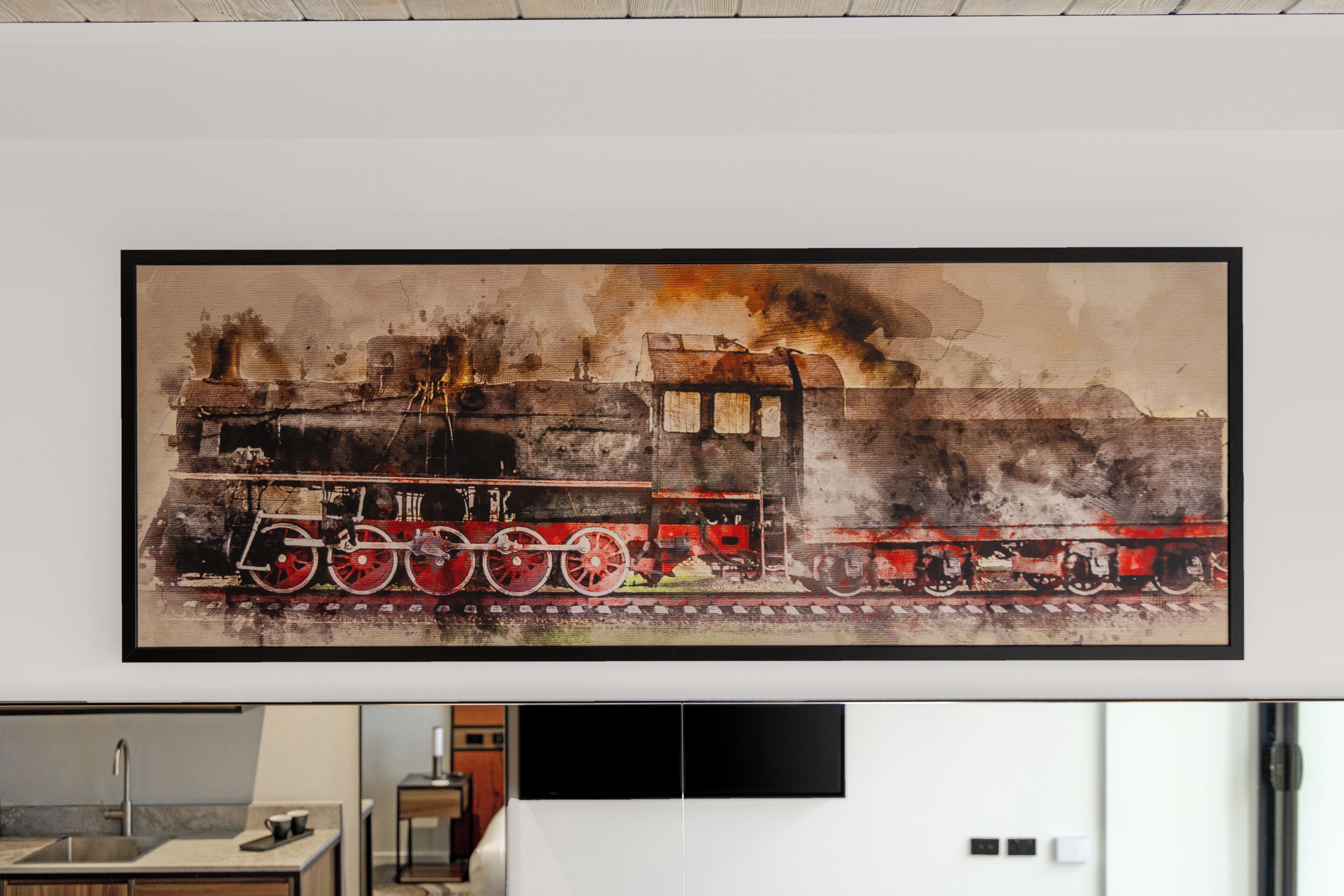 A framed artwork of a train on a track with a building in the background.