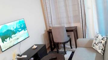 Deluxe Studio Suite, City View | Living area | 24-inch Smart TV with digital channels