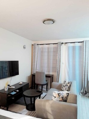 Deluxe Studio Suite, City View | Living area | 24-inch Smart TV with digital channels - Lux Suites Chapell Hill Apartments  (Ngong)