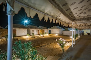 A spacious courtyard with a patterned ceiling, multiple rooms with doors, and a central seating area. - Robin Desert Safari Camp  (Jaisalmer)