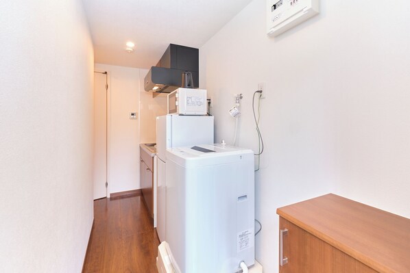 A compact kitchen with a refrigerator, microwave, and a small sink. - Le Cocon Nakarokugo by Tranova (Tokyo)