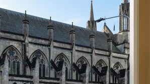 A historic building with Gothic architecture, featuring pointed arches and intricate window designs. - Star Struck on Stuart Street (Dunedin)