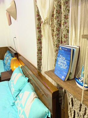 A bedroom with a wooden bed, a bedside table with a book, and a lamp. - Sea-breeze homestay (Phu Thuy)