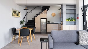 A modern apartment with a dining area, kitchen, and living room. - Deluxe Inner-city Apartment on Moray (Dunedin)