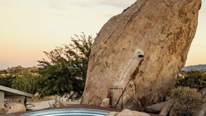 A hot tub on a wooden deck with a large rock nearby. - Bijou • Romantic Sanctuary, Hot Tub in Boulders (Yucca Valley)