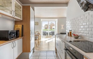 Fridge, stovetop, dishwasher, coffee/tea maker