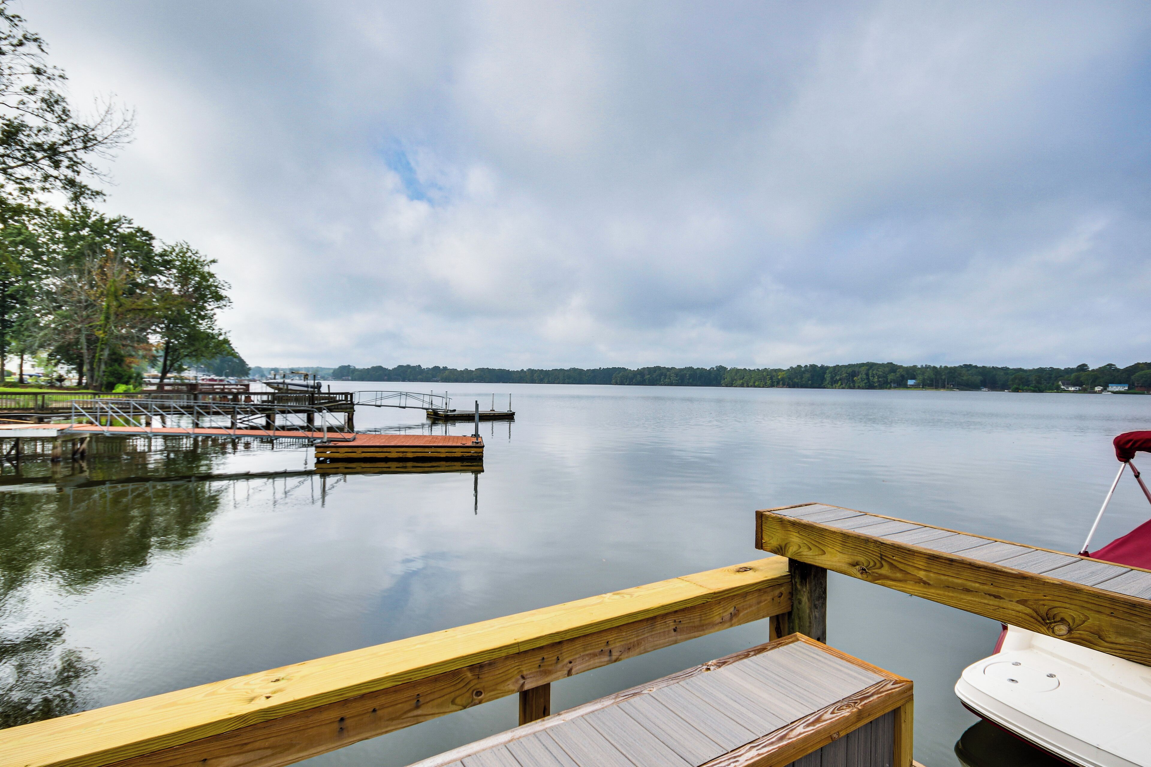 A calm lake with wooden docks and a boat.