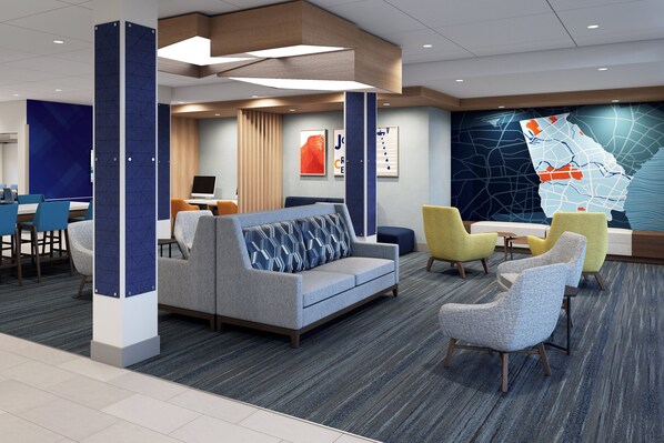 A modern hotel lobby with a sofa, chairs, a desk, and a map on the wall. - Holiday Inn Express & Suites Cushing by IHG (Cushing)