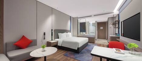 Una habitación de hotel moderna con cama, sofá, escritorio y televisión.