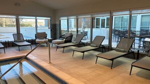 A poolside area with sun loungers and a pool. - Element by Marriott Fort Smith (Fort Smith)