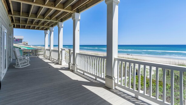 A wooden deck with white railings overlooking a beach. - Aqua Vista | Oceanfront 5BR w/ Private Pool, Hot Tub & Stunning Views (Emerald Isle)