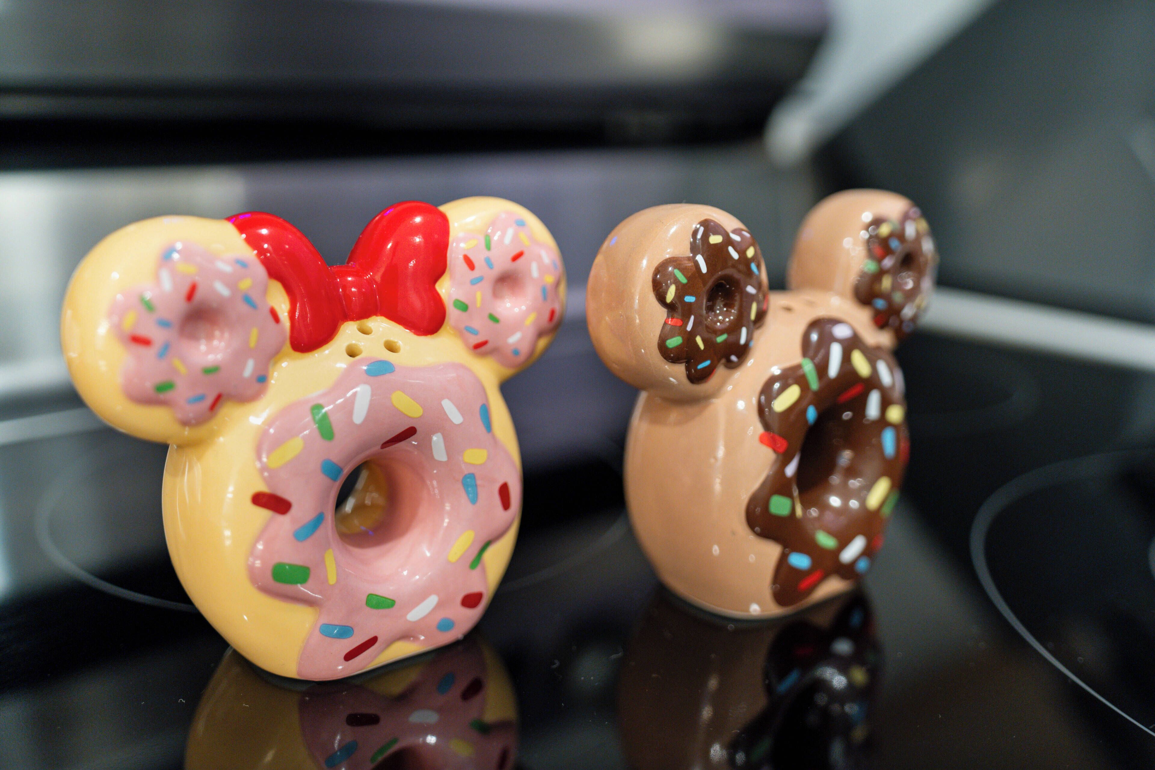 Two ceramic figurines of bears on a reflective surface.