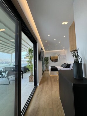 Deluxe Penthouse, Harbor View | Living area | Flat-screen TV - BlueMotion - CentralSuite (Piraeus)