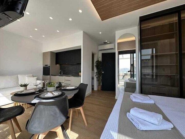 Deluxe Apartment, Private Bathroom, Harbor View | Living area | Flat-screen TV - BlueMotion - CentralSuite (Piraeus)