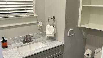 Shower, hair dryer, towels, toilet paper