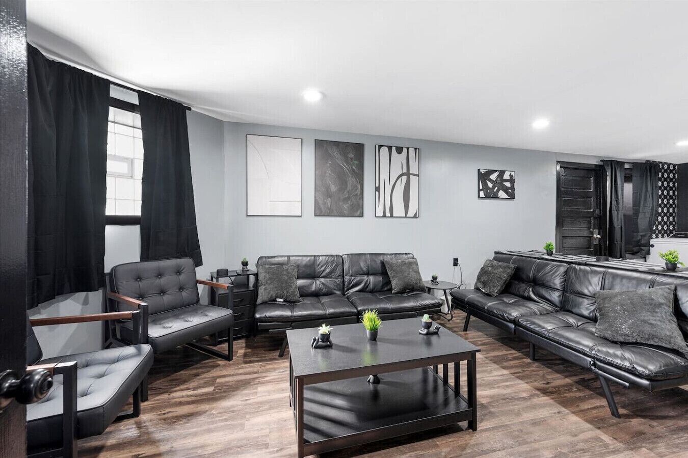 A modern living room with a sofa, armchair, and coffee table.