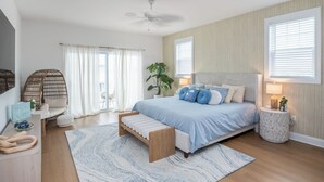 A bedroom with a bed, bedside tables, a bench, a plant, and a ceiling fan. - Seaside Zen Retreat 4-bedroom house in beautiful Seaside Heights with AC, WiFi (Seaside Heights)