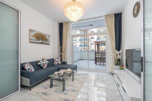 Lägenhet Deluxe | Vardagsrum | Platt-tv