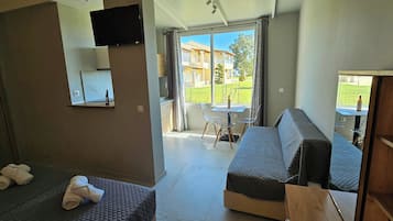 Luxury Apartment, Lanai, Courtyard View | Living area | 32-inch flat-screen TV with digital channels, TV