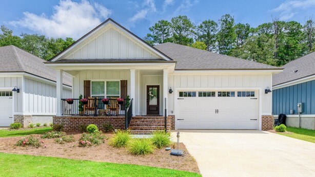 A single-story house with a front porch, a garage, and a well-maintained lawn. - Fully-Fenced Backyard! Perfect for Families/Groups (Tallahassee)