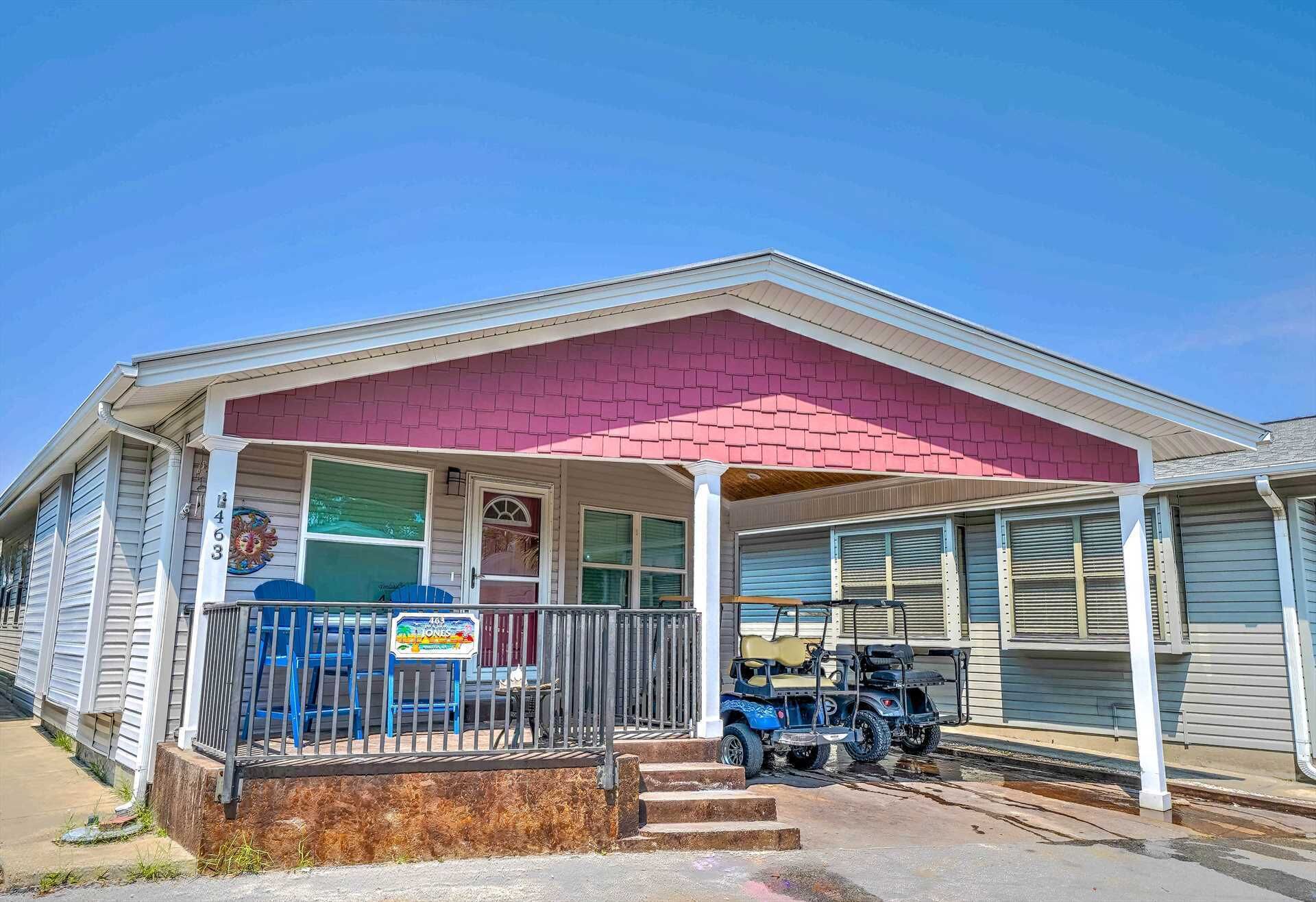 A single-story house with a covered porch, a garage, and a small front yard.