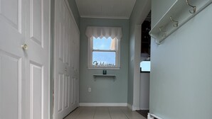 A hallway with a welcome mat, a window with a 'Welcome' sign, and a door. - Escape to your private oasis in our ocean front home with breathtaking views.  (Grand Bank)