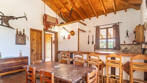 A rustic dining area with wooden furniture and a high wooden ceiling. - Beautiful home in Alora with WiFi (Alora)