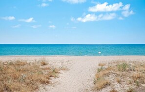 A sandy beach with a clear blue sky and calm sea. - 1 bedroom stunning apartment in Marina di Modica (Marina di Modica)