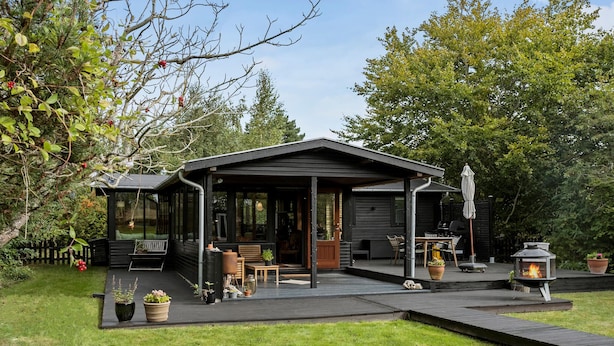 A modern outdoor patio area with a covered seating space, a barbecue grill, and a fire pit. - Nice home in Gørlev with WiFi (Gørlev)