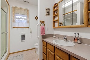 A bathroom with a toilet, sink, and shower. - Mack and Spot House with incredible views! (Emmett)