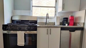 A kitchen with a stove, oven, cabinets, and a dishwasher. - 1601 Lombard  (Philadelphia)