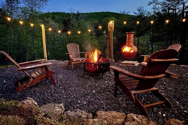 Relax as the sun sets over the mountains - fire pit warmth included!