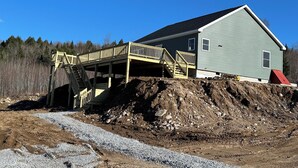 A house with a covered deck and stairs leading to the entrance. - ADK cottage with Mountain Views  (Saranac)