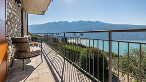 A balcony with a view of mountains and a body of water. - Holiday Apartment "Il Cinque" with Lake View, Shared Pool & Wi-Fi (Tignale)