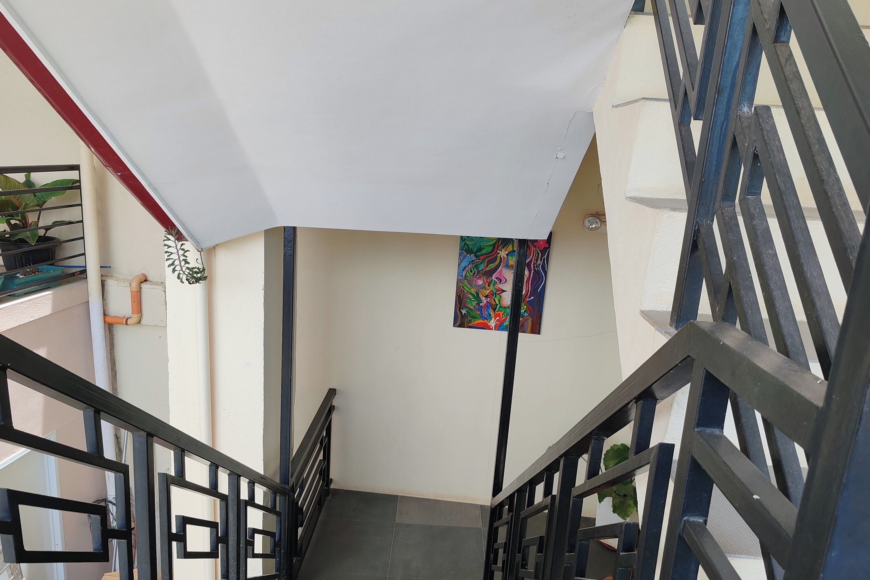 A staircase with black railings and a white awning.