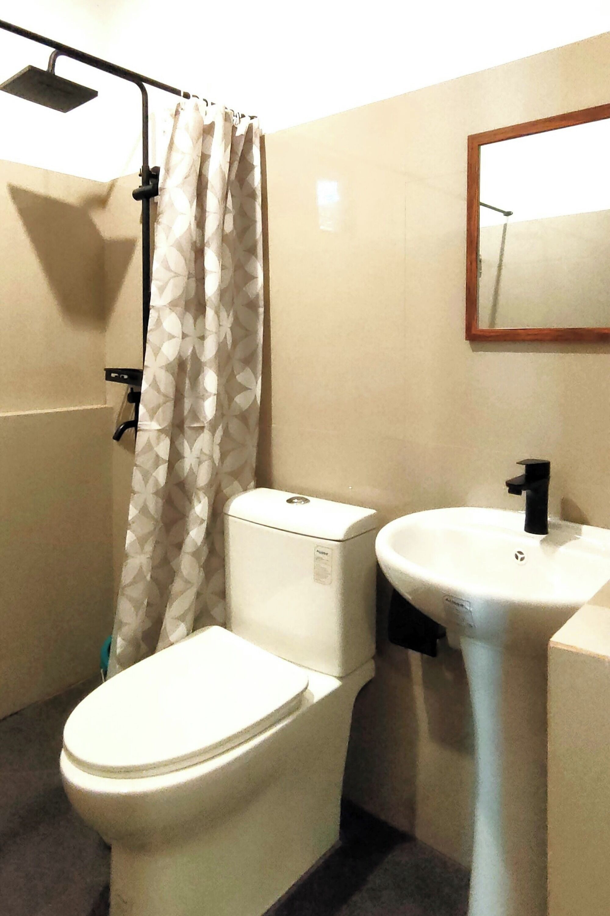 A bathroom with a toilet, a sink, and a shower.