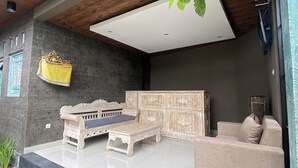 A modern outdoor seating area with a sofa and a cabinet. - Nivaluma By Zuzu (Mas)