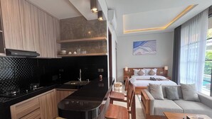 Suite Pool Access | Living area | 24-inch flat-screen TV with cable channels - Ranala Coliving (Keroboken Kelod)