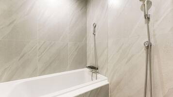 A modern bathroom with a bathtub and a shower.