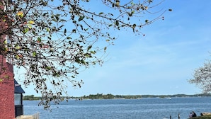 A park bench overlooking a lake with a clear view of the water and distant shoreline. - Cozy, Clean, Convenient and Spacious 3-bedroom apartment in beautiful Clayton. (Clayton)