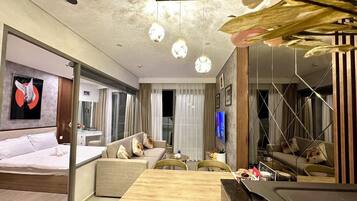 Deluxe Apartment | Living area | 45-inch Smart TV with cable channels, pay movies