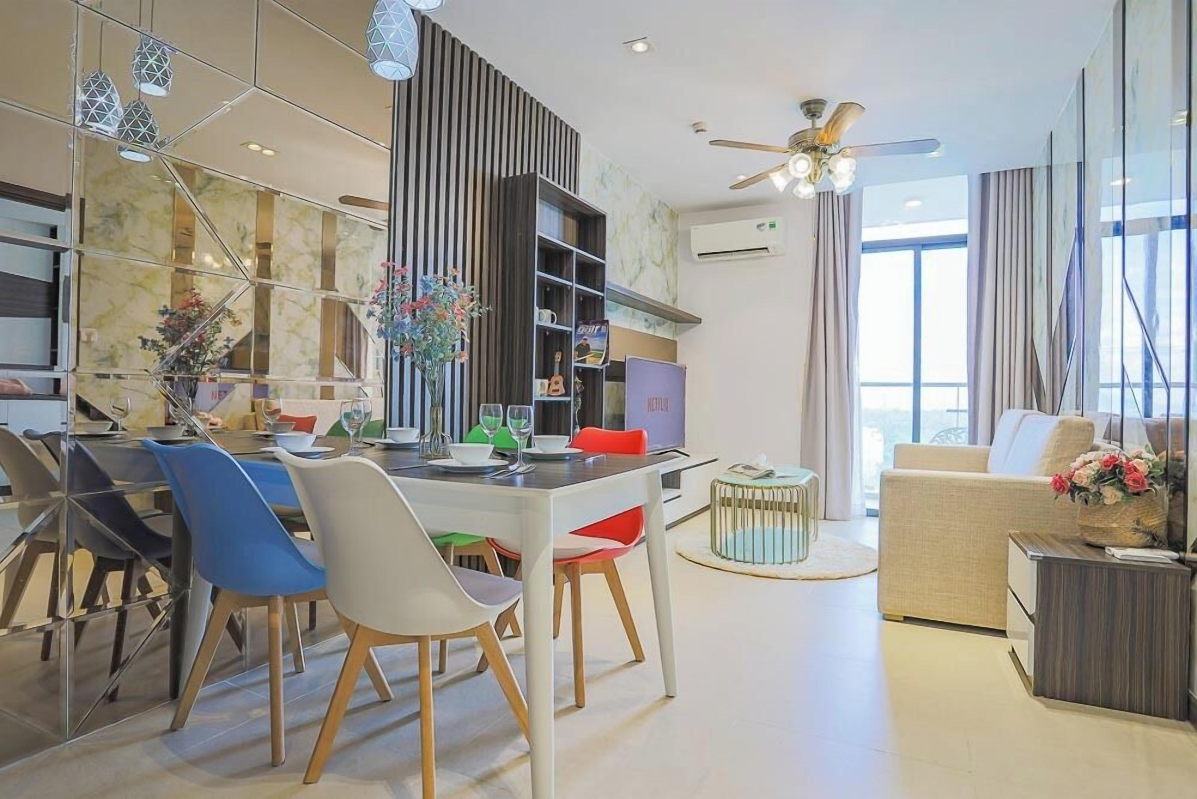 Un salon moderne comprenant un coin repas, un canapé, une table basse et un téléviseur.