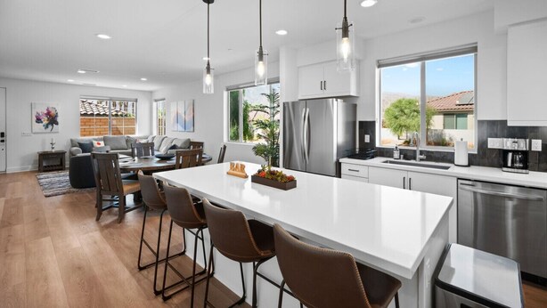 A modern kitchen with a large island, stainless steel appliances, and pendant lighting. - PGA Signature at its FINEST, Steps to resort, Game Room, Luxe Interior (La Quinta)