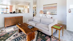 A modern living room with a sofa, coffee table, and side table.