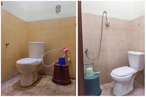 Bathroom features a toilet and shower area with beige tile walls and a patterned tile floor.