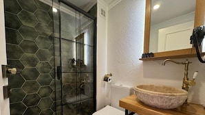 A bathroom with a glass shower enclosure, a toilet, a sink with a vessel basin, and a towel rack. - Abelia Mansion Hotel (Istanbul)