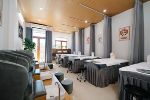 A hotel room with a sofa, a dining table with chairs, a small kitchen area, and a large window with curtains. - Danang Private Swimming Pool Villa (Da Nang)