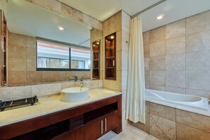 A modern bathroom with a large sink, mirror, and bathtub. - Danang Private Swimming Pool Villa (Da Nang)