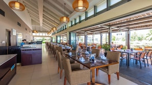 A spacious restaurant with high ceilings, large windows, and wicker furniture. - Danang Private Swimming Pool Villa (Da Nang)