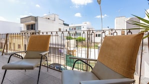 A balcony with two beige chairs and a metal railing. - 4086 Maison Malù by Barbarhouse (Nardò)
